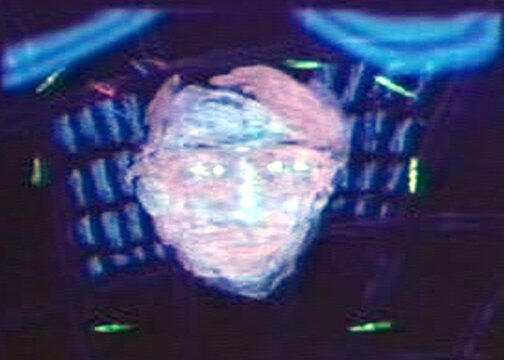 still from "PedantPhilia" blacklit glowworms with professor's head